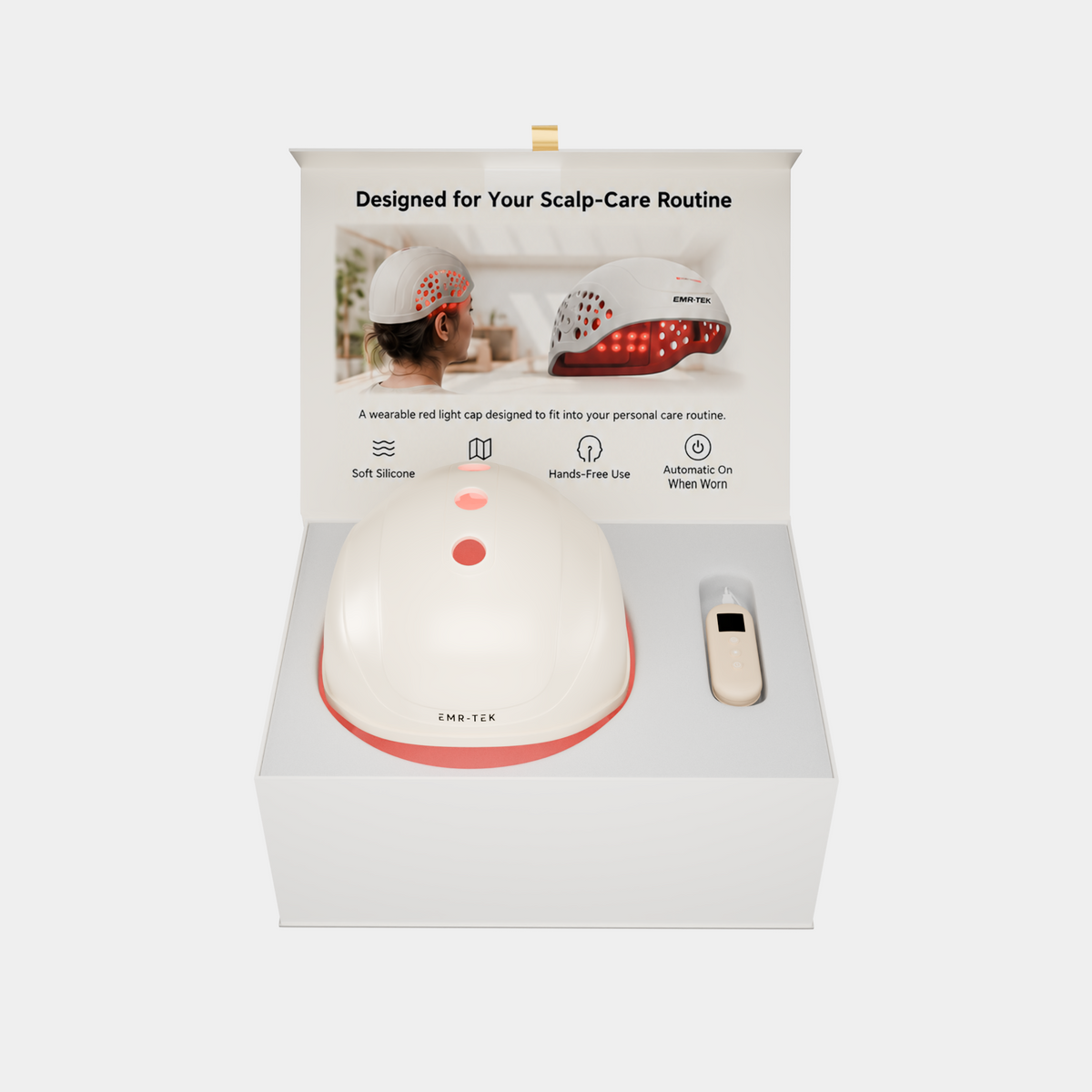 A red and white scalp massager shown inside its white retail box, with a small remote control placed beside the device. The box includes printed product features and usage imagery on the inner lid.